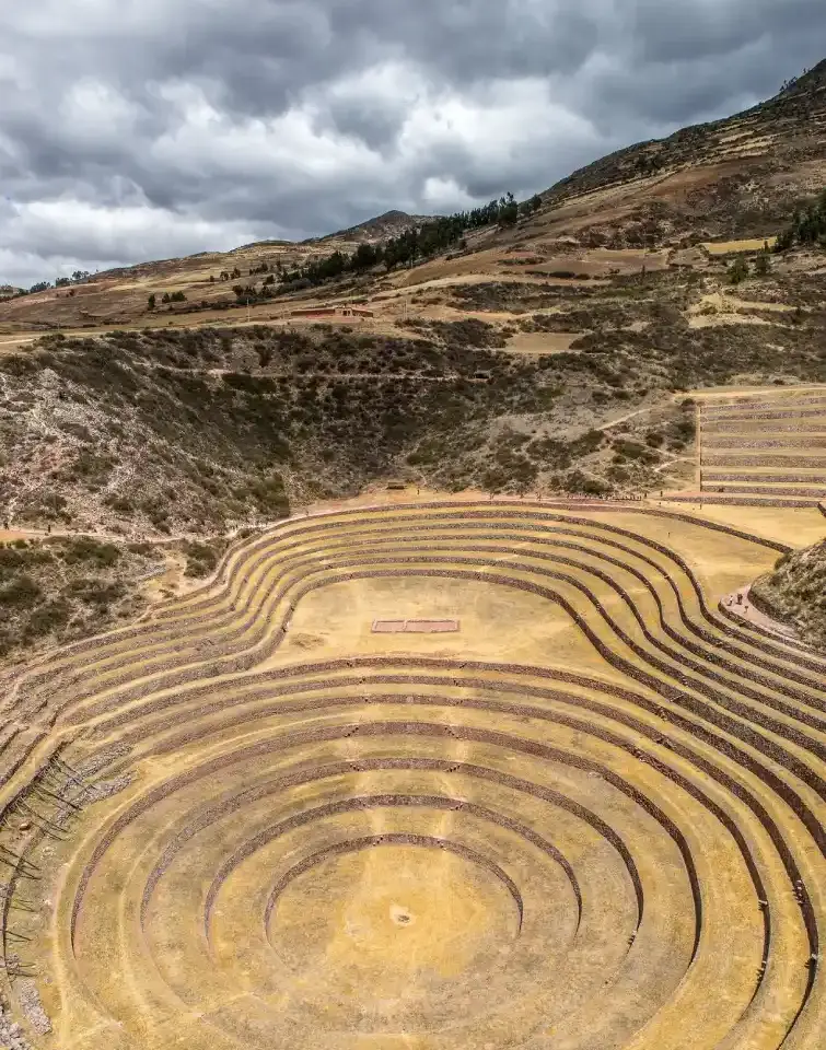 Ancient circular agricultural terraces surrounded by the Andean highlands.
